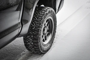 Winter tires with deep treads covered in fresh snow