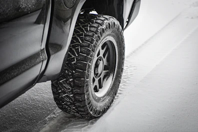 Winter tires with deep treads on a snowy road