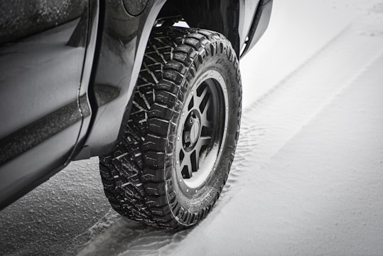 A rugged tire gripping a wet road surface during a rainy drive.
