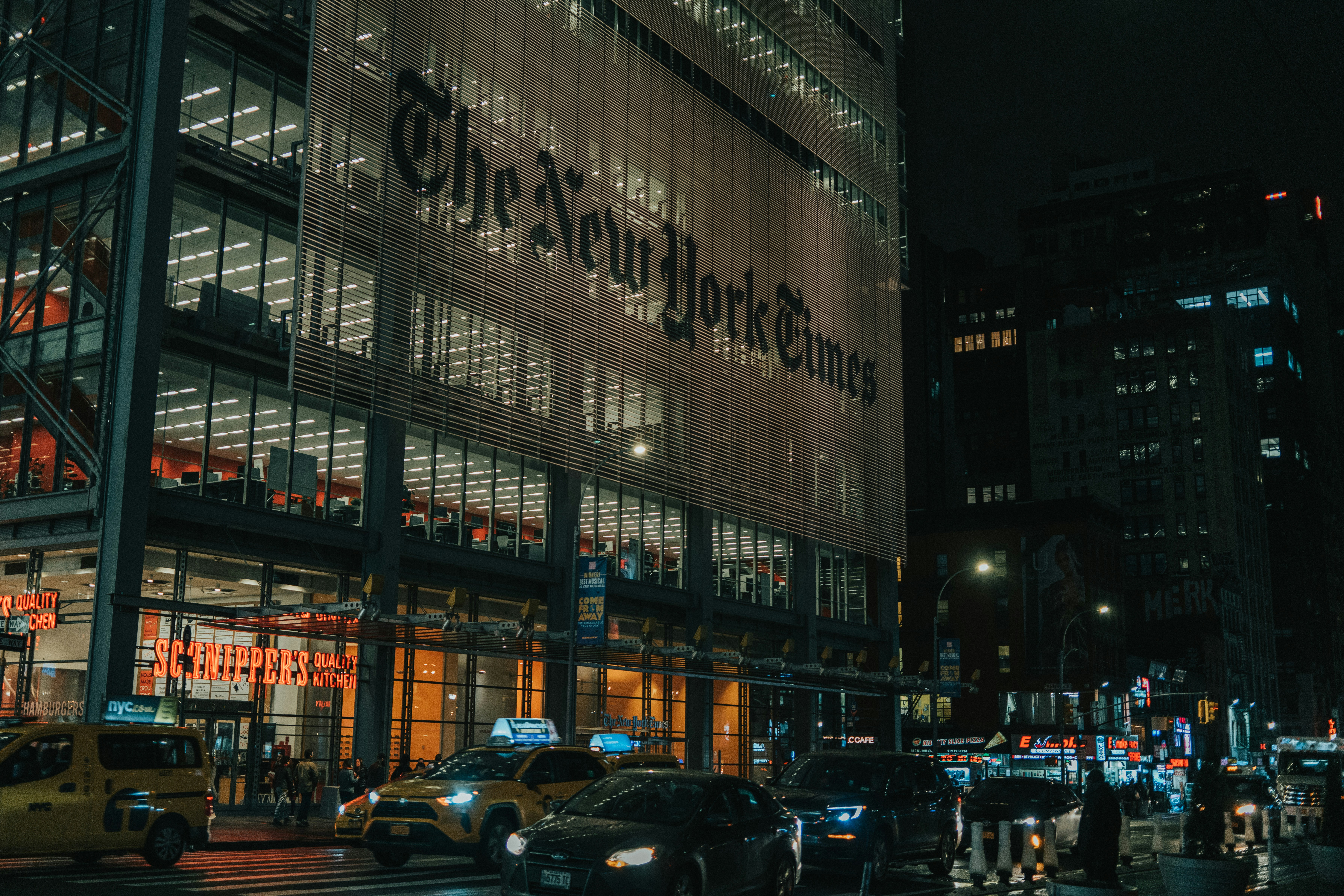 cars parked in front of building during night time