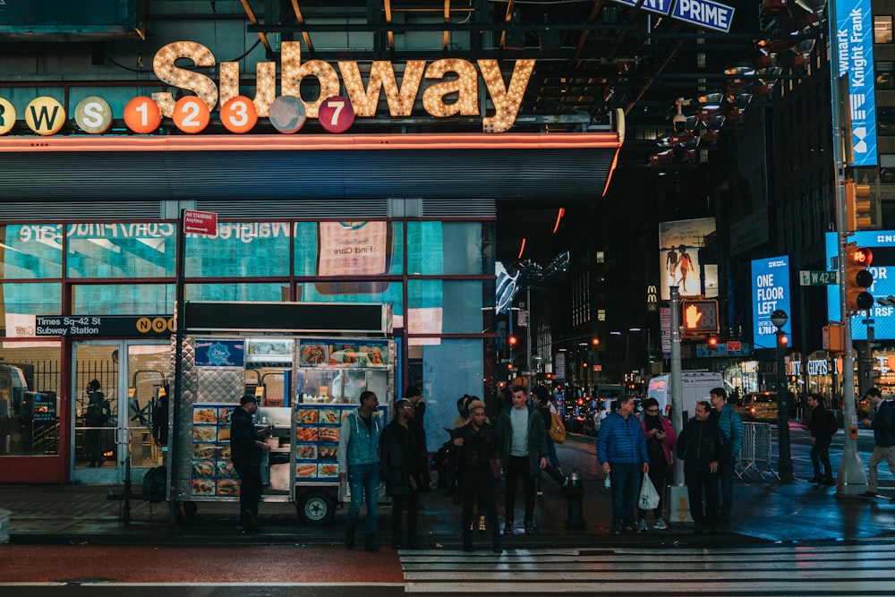 people walking on street during nighttime