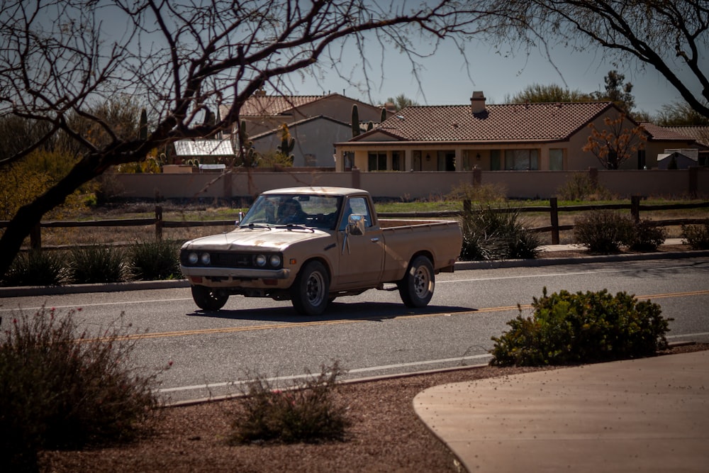 brown crew cab pickup truck parked on road side during daytime