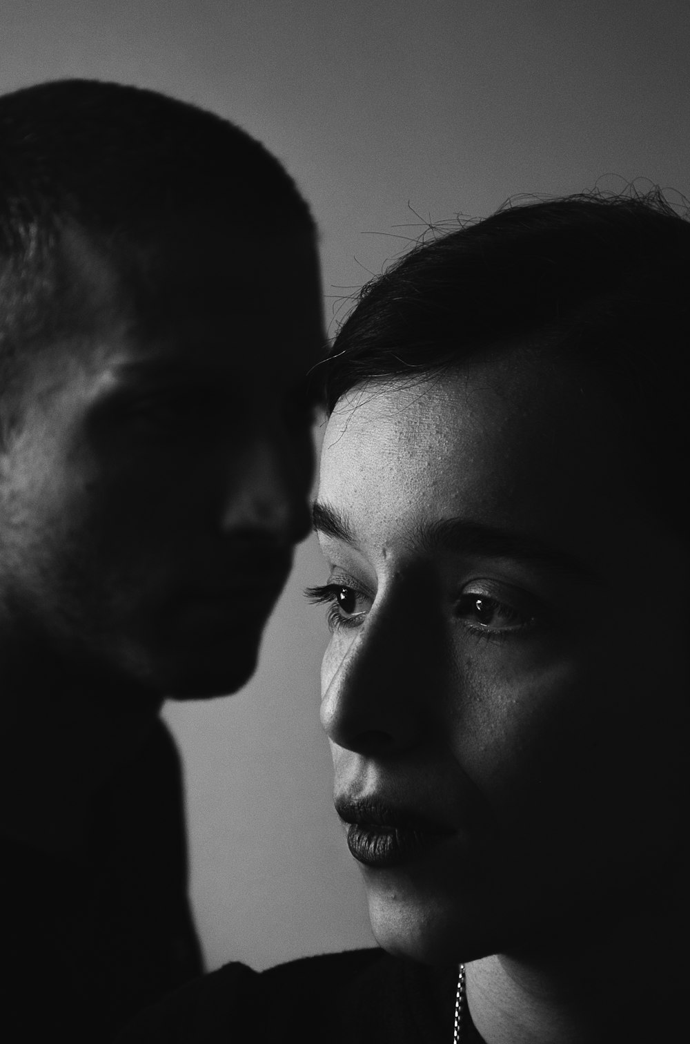 man and woman in grayscale photography