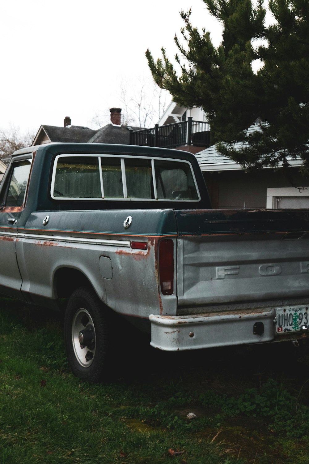 white and red chevrolet crew cab pickup truck parked on green grass field during daytime