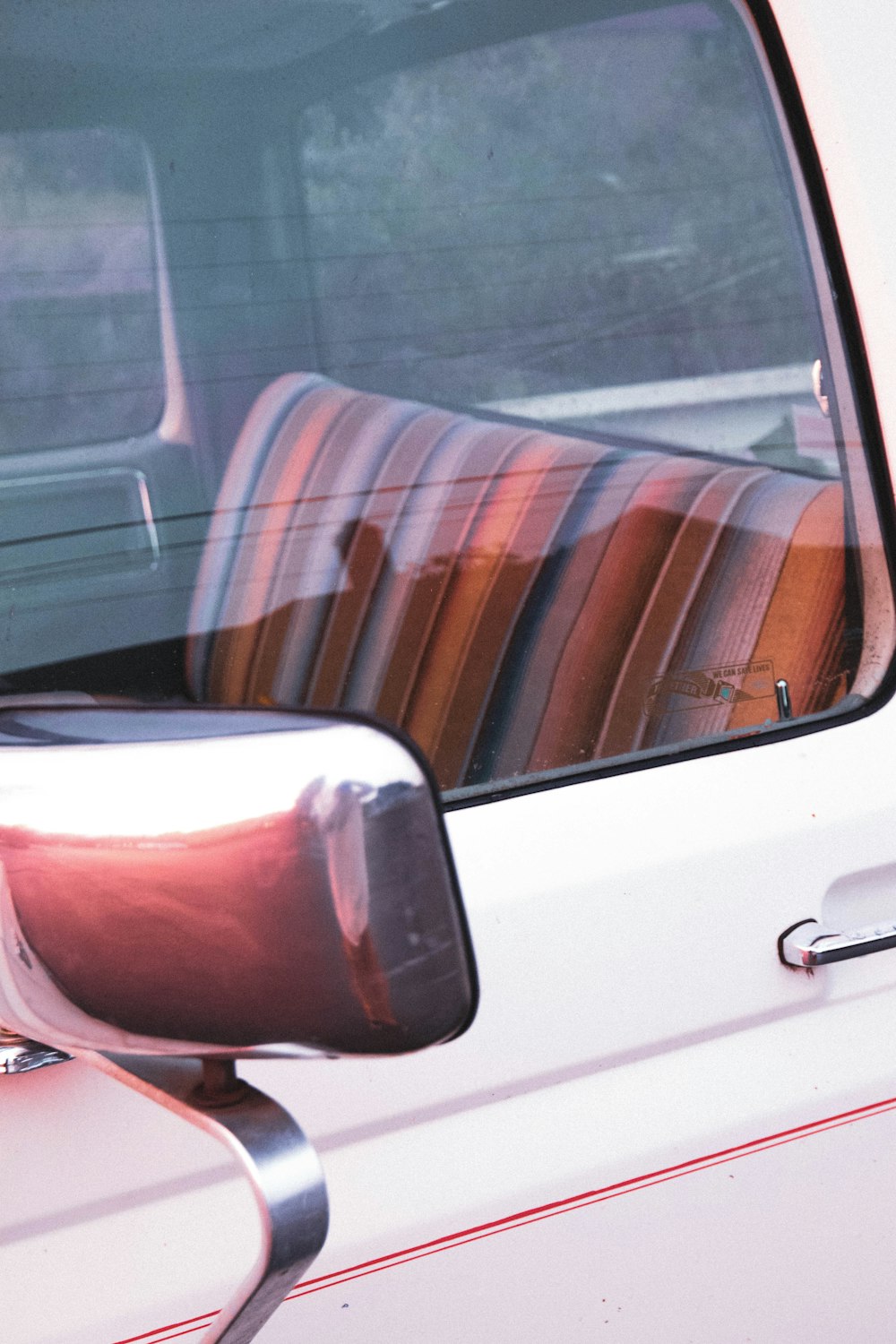 white car door with brown and white striped seat