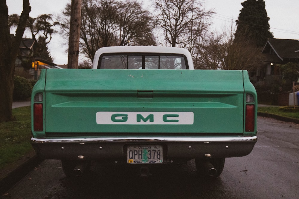 green chevrolet pickup truck parked on road side during daytime