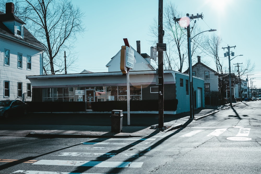 blue and white concrete building near bare trees during daytime