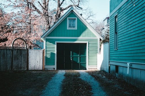 blue and white wooden house near brown trees during daytime