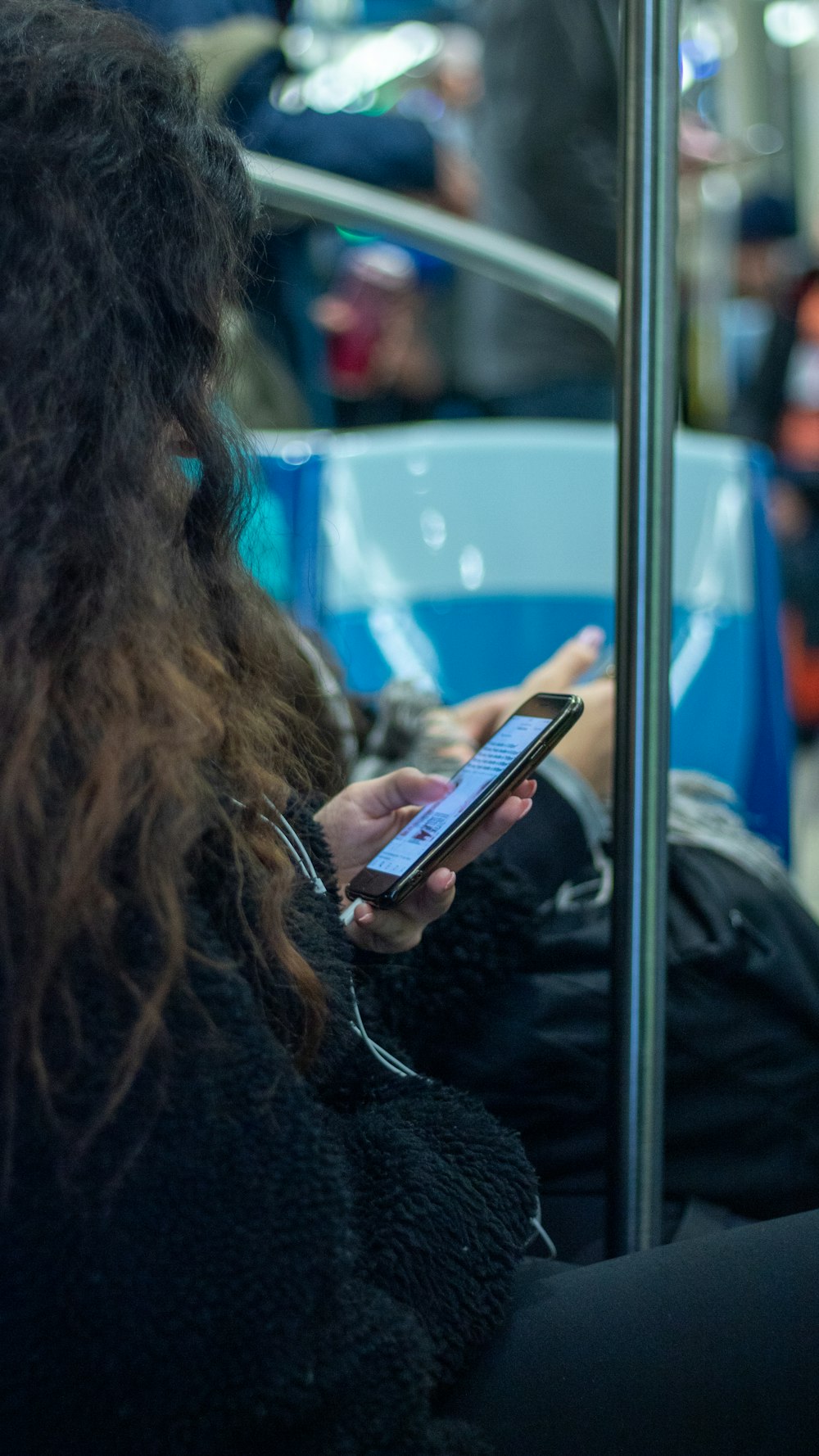 woman using smartphone in train