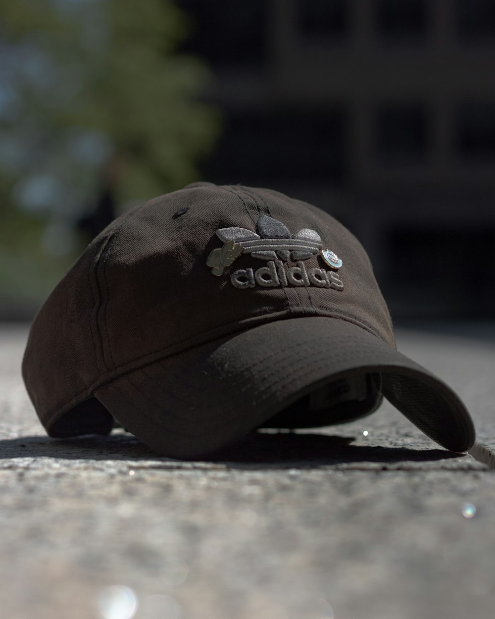brown and black fitted cap on grey concrete floor