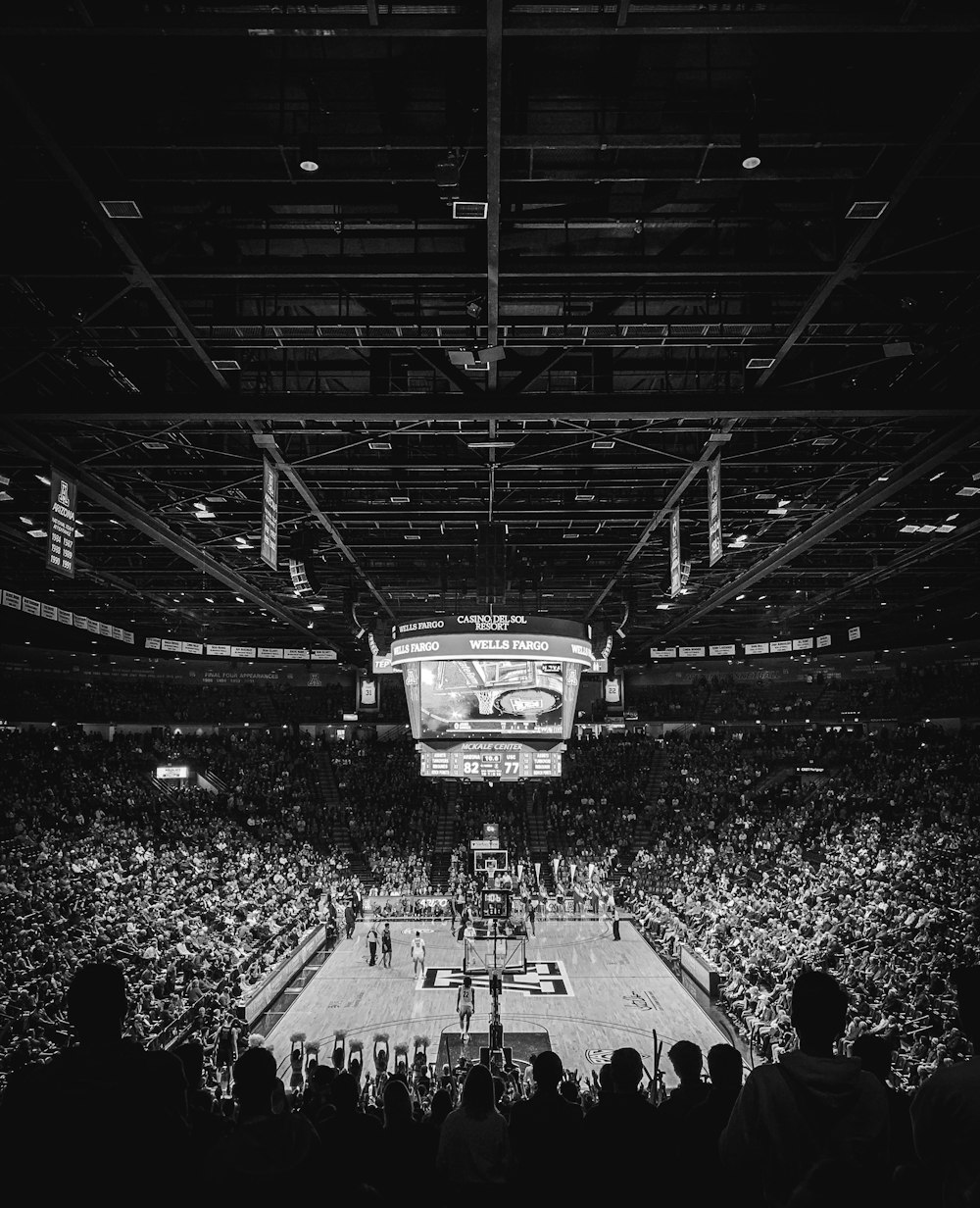 grayscale photo of people in stadium