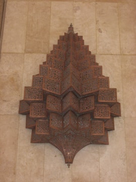 Close-up of a hand-painted wooden wall decoration with intricate laser-cut patterns.
