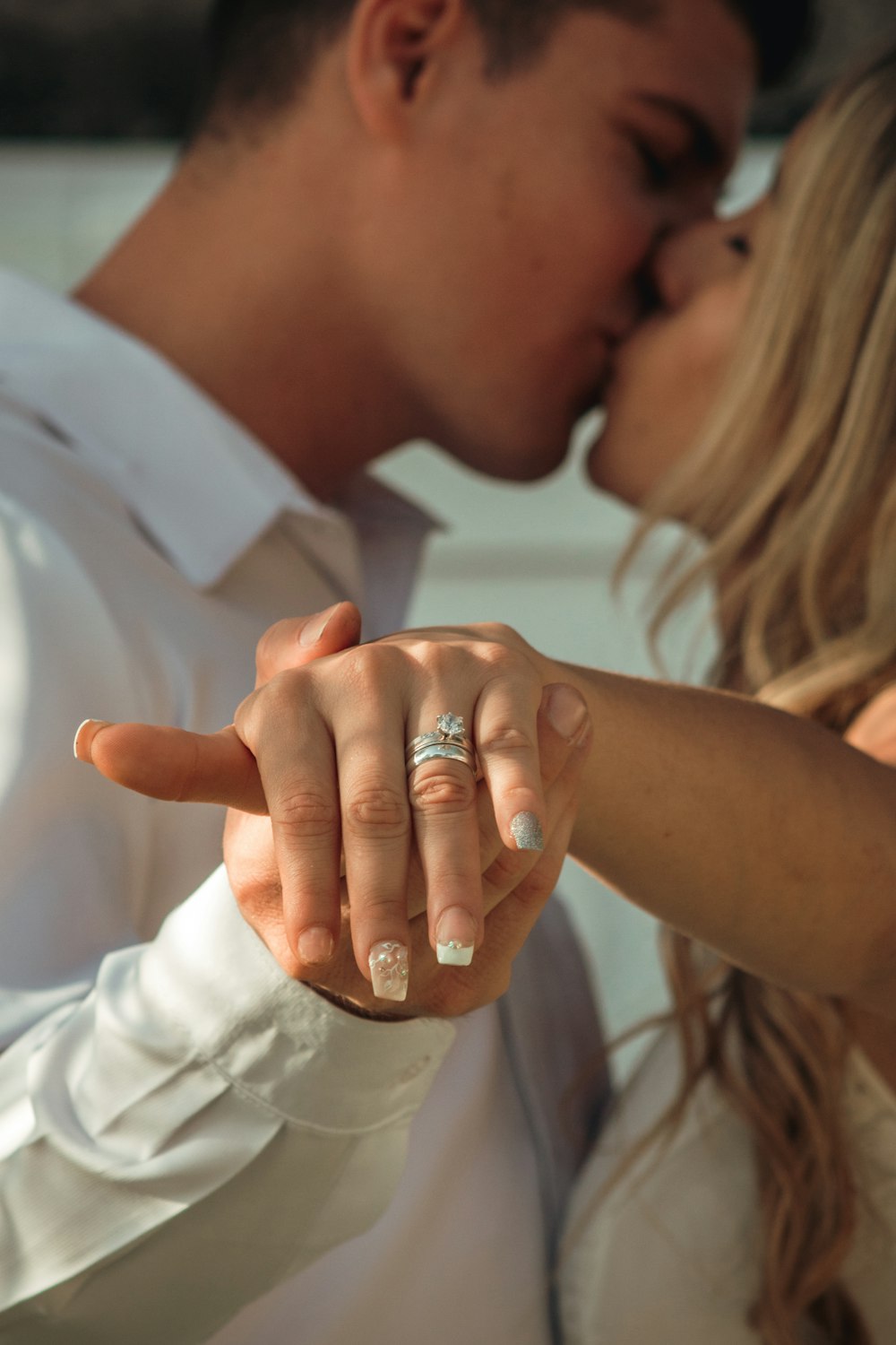 woman in white dress shirt wearing silver ring