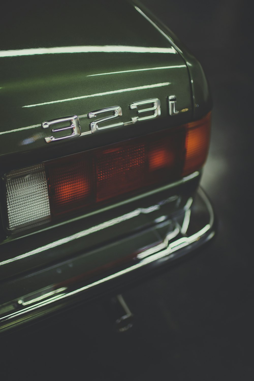 green and black car in close up photography