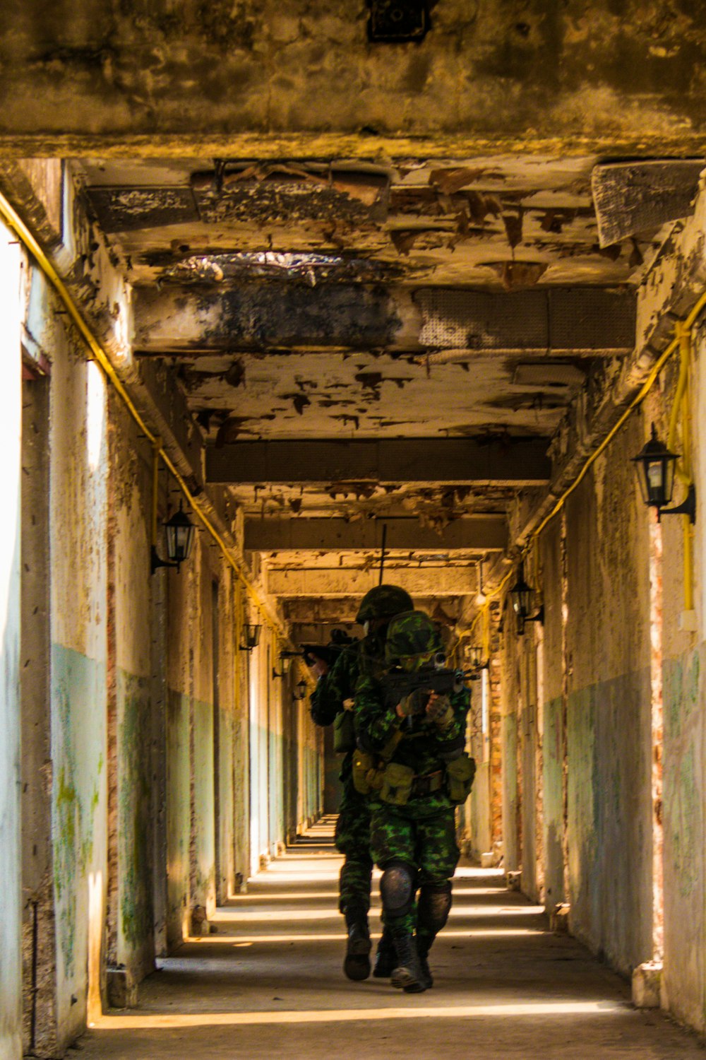 man in green jacket standing on hallway