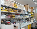 white wooden shelf with bottles and boxes
