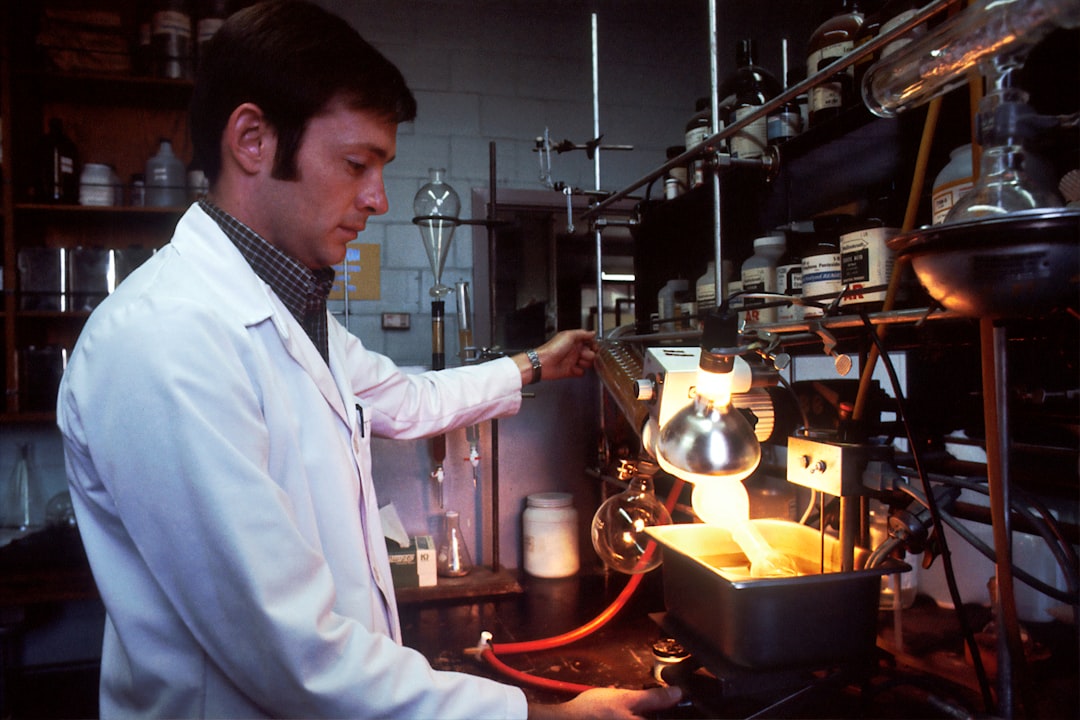 man in white chef suit holding stainless steel kettle