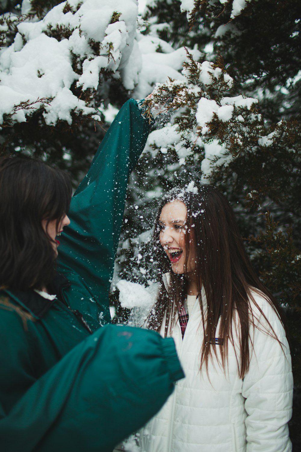 woman in green jacket standing near green tree during daytime