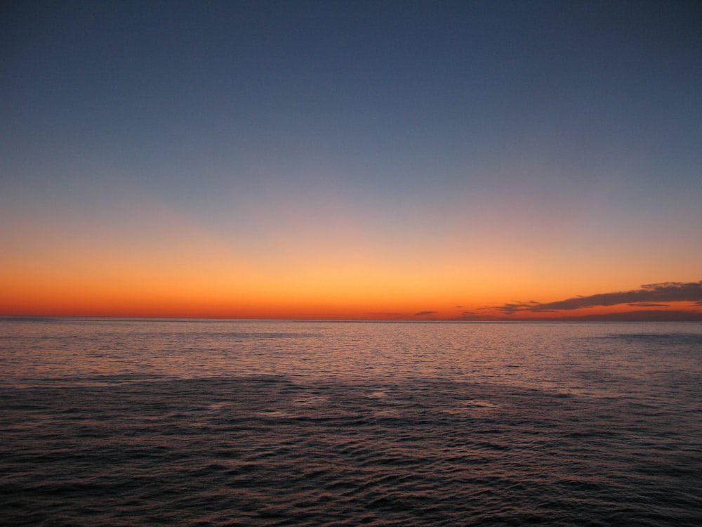 body of water during sunset