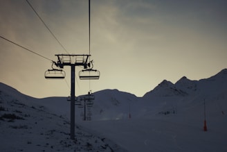 cable car over snow covered mountain