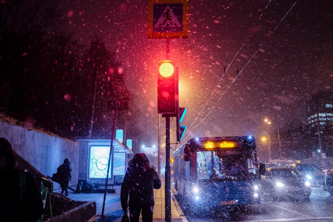 silhouette of person standing near traffic light during night time