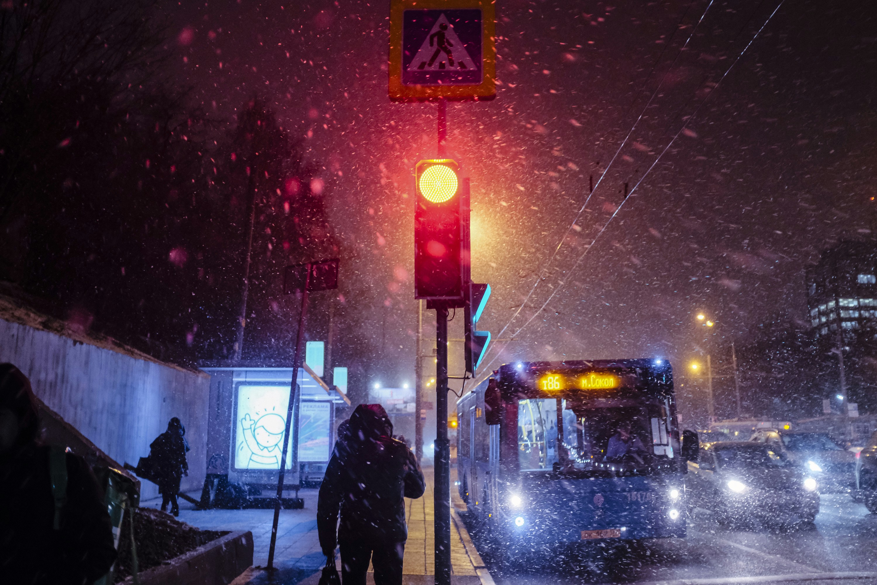 silhouette of person standing near traffic light during night time