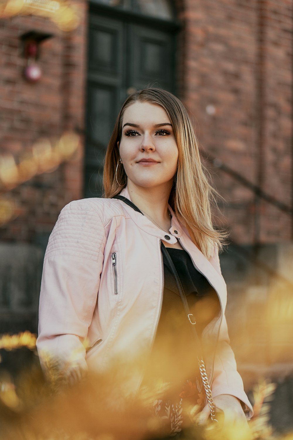 woman in pink zip up jacket smiling