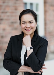 Woman smiling confidently while wearing a tailored blazer