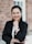 woman in black blazer smiling