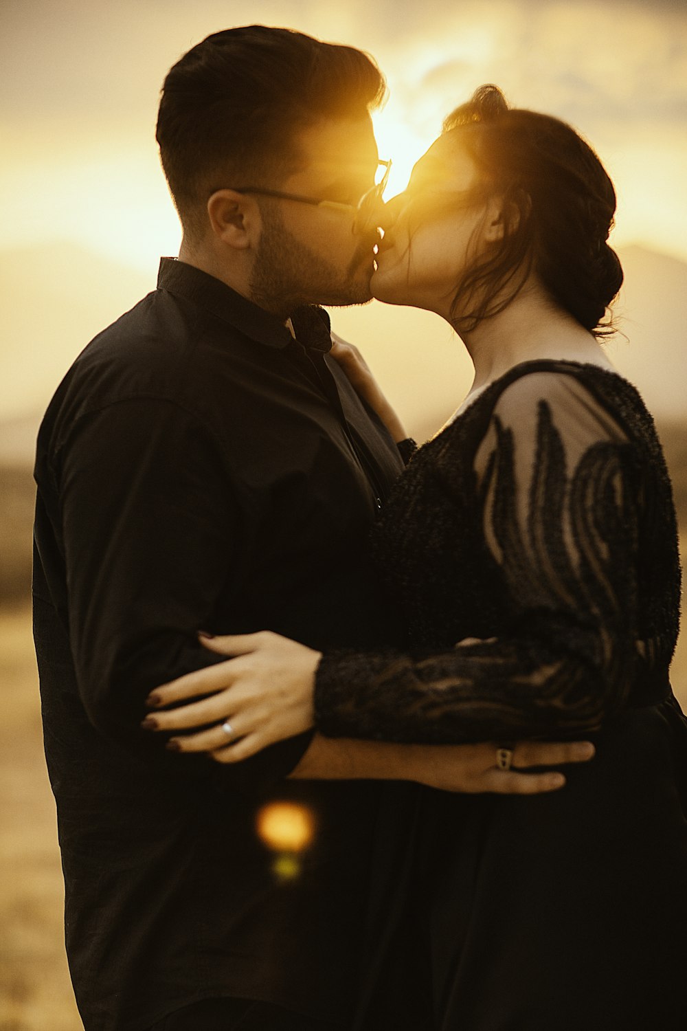 man in black dress shirt holding lighted candle