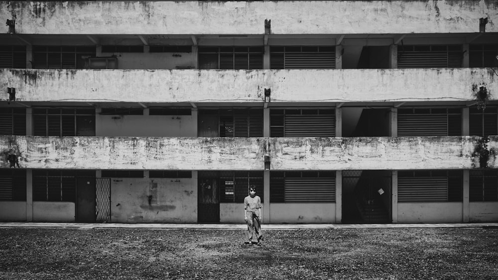 grayscale photo of 2 children playing on field