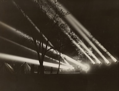 Strong white beam illuminating the sky in search for drones and enemy vehicles
