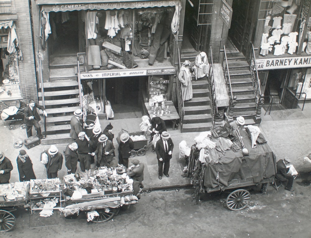 grayscale photo of people in front of car