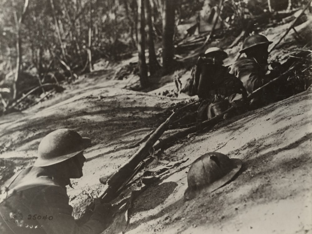 grayscale photo of 2 american soldiers sitting on ground in the first world war
