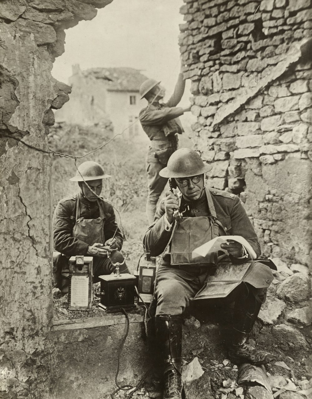 grayscale photo of 2 male soldiers in World War 1 on the telephone