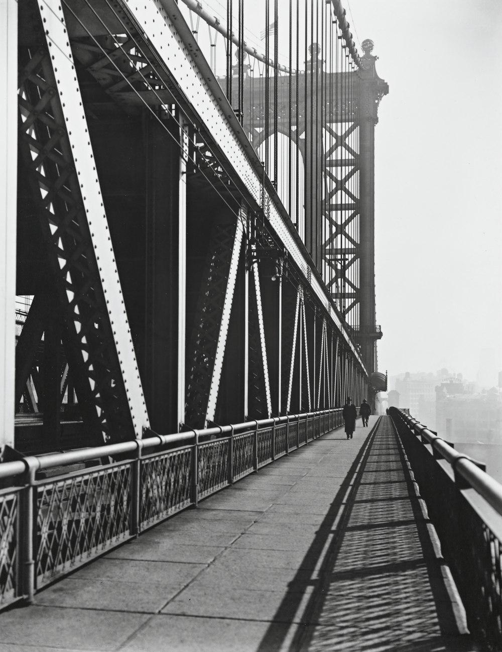 grayscale photo of Manhattan bridge with people walking