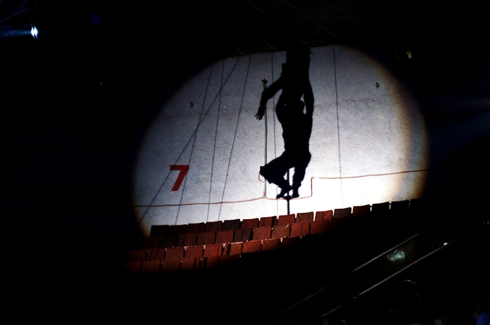 silhouette of man walking on tunnel