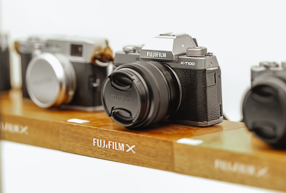 black and silver nikon dslr camera on brown wooden table