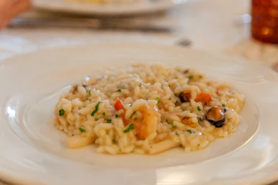 Seafood pasta served with white wine on a dining table