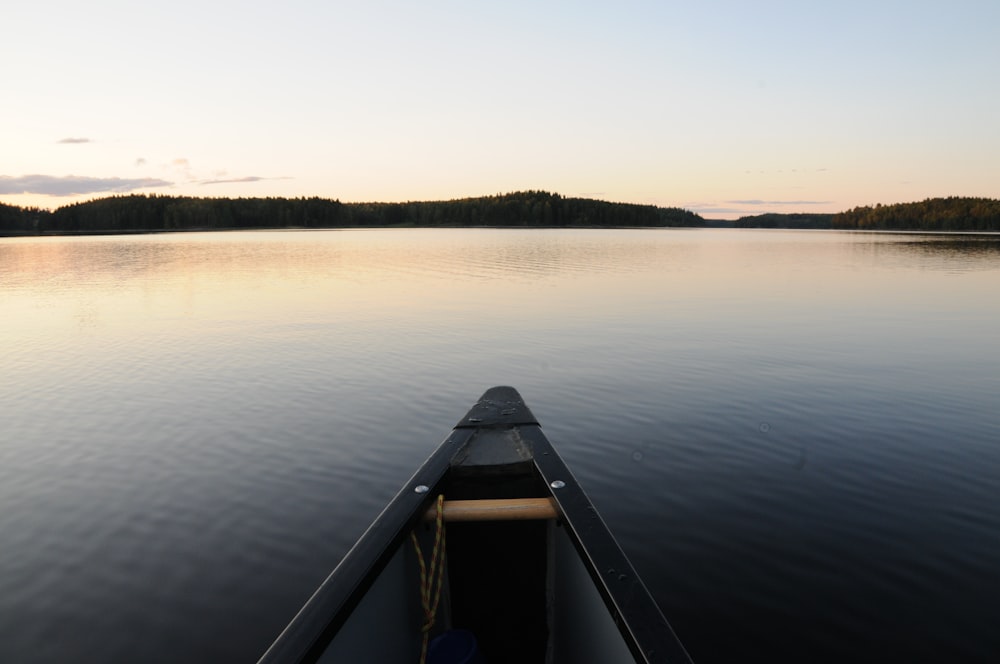 brown wooden boat on lake during daytime