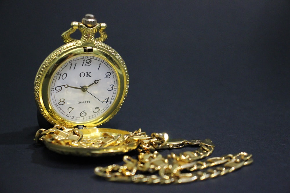 gold and silver pocket watch