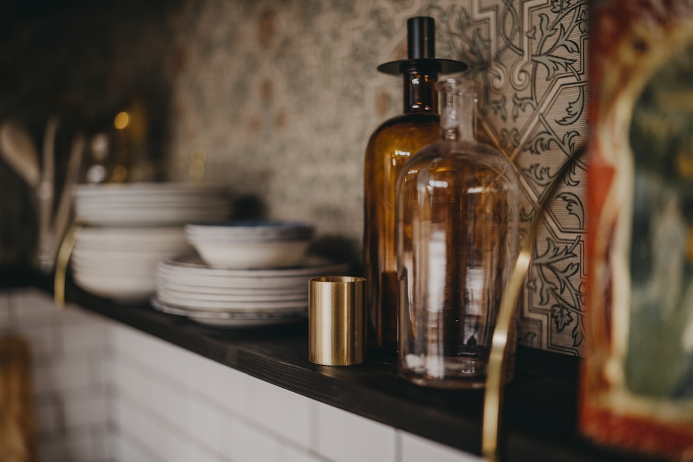 clear glass bottle on brown wooden table