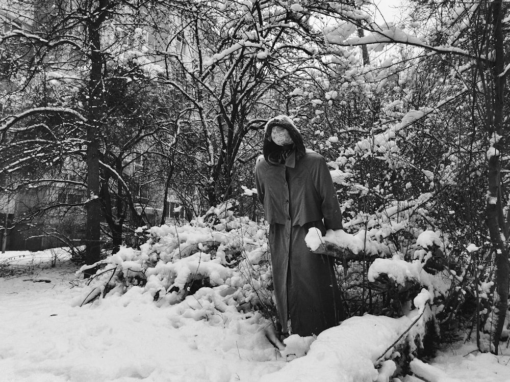 person in black hoodie standing on snow covered ground during daytime