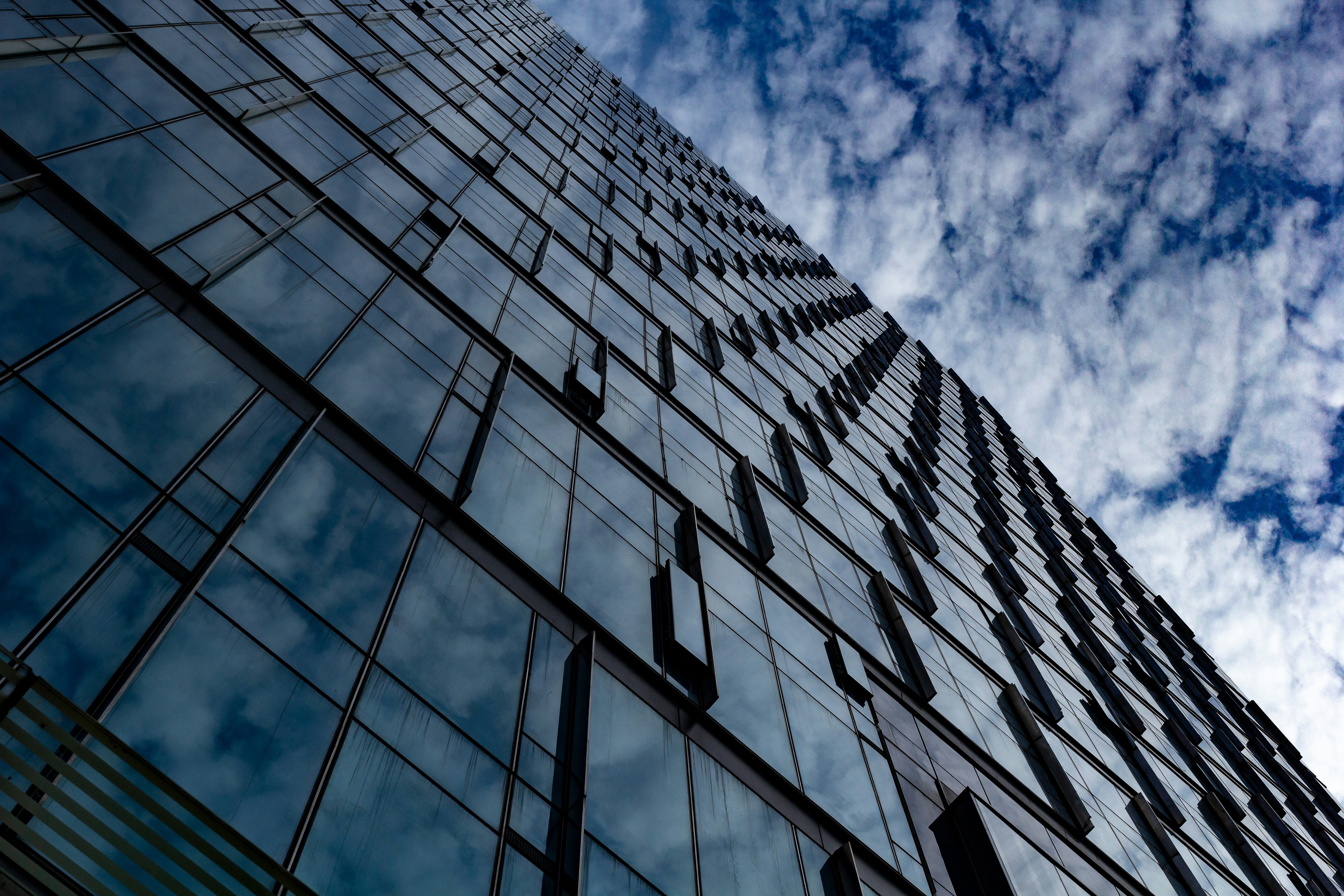 low angle photography of glass building under blue sky during daytime