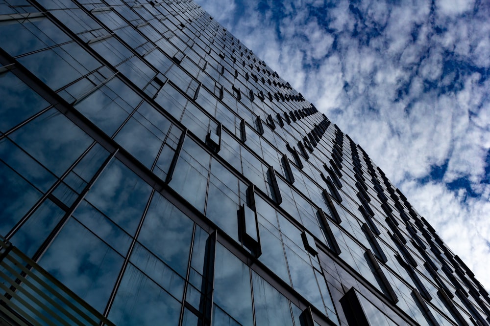 low angle photography of glass building under blue sky during daytime