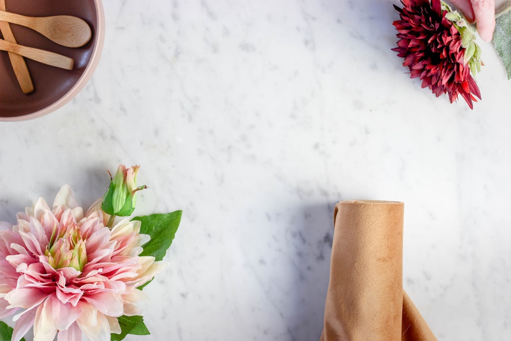 pink and white flower on brown paper bag