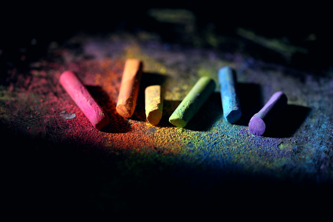 red white and green color pencils, Rainbow chalk on black.