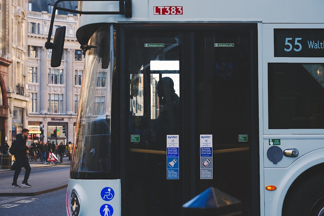 white and blue bus on road during daytime