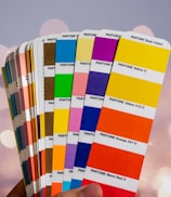Close-up of vibrant color swatches and typography samples on a desk.