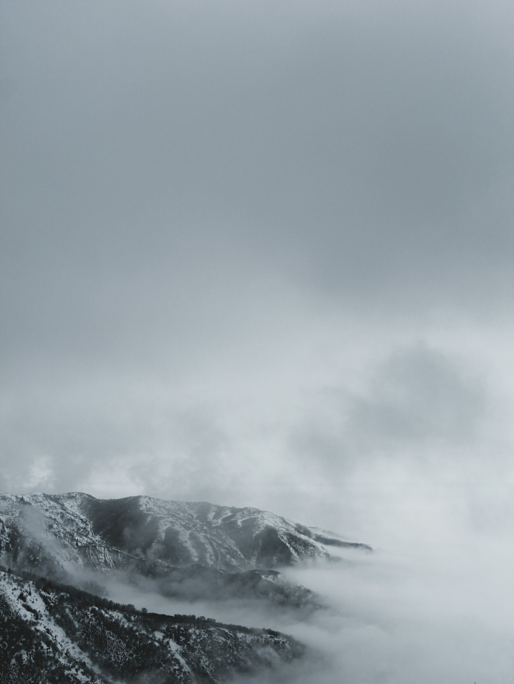 montanha coberta de neve sob céu nublado durante o dia